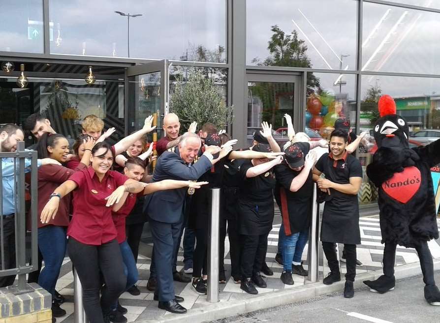 Cllr Roger Dalton, mayor of Tonbridge and Malling, "dabs" with members of Nando's staff at the opening.