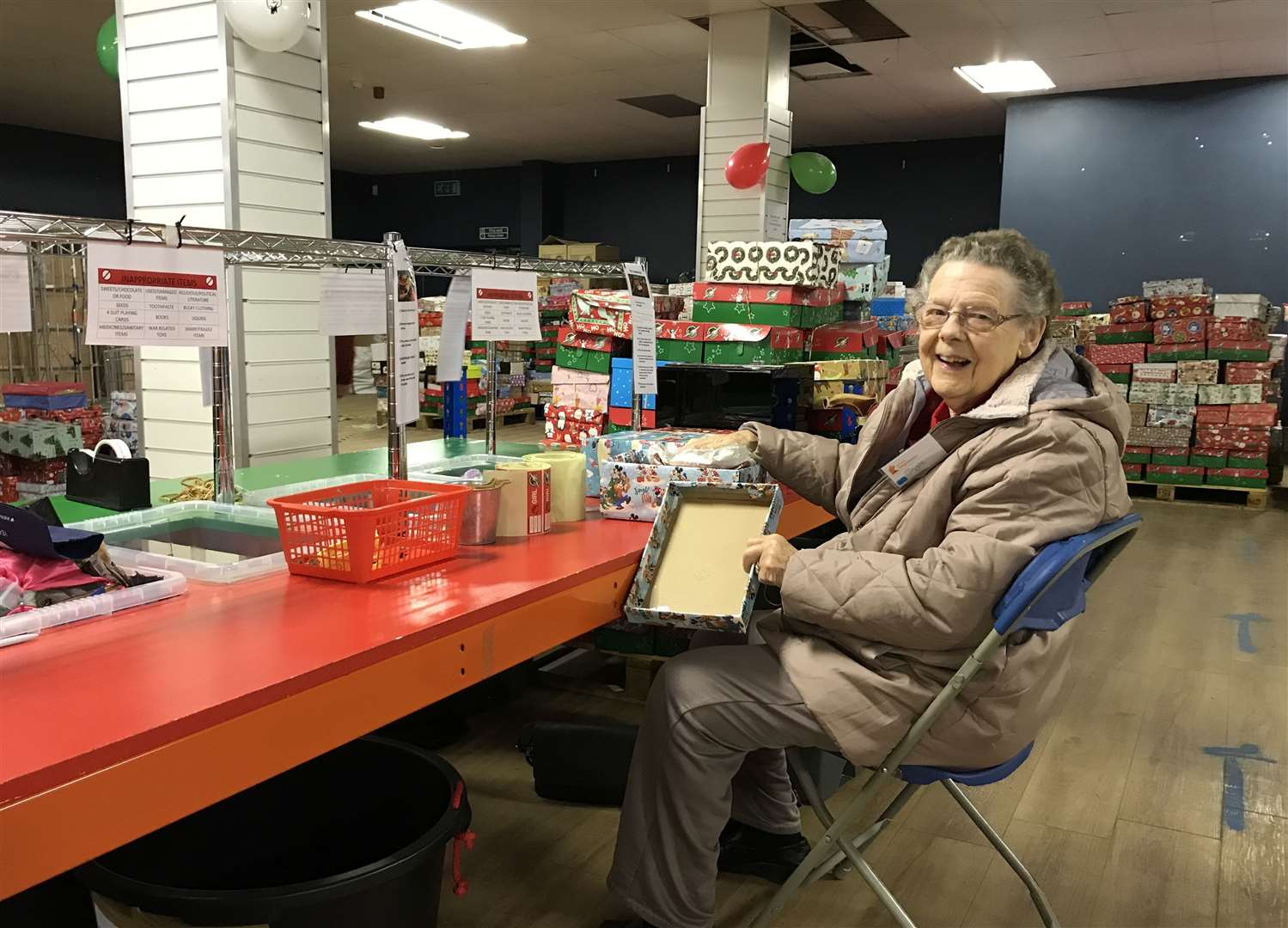 Joyce Alcock helps check boxes for the charity