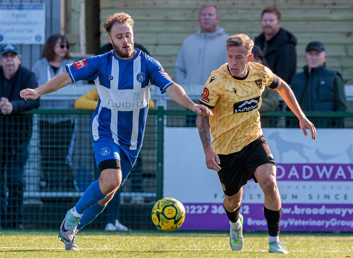 Maidstone’s Sam Corne is up against Herne Bay’s Jack Parter during their FA Cup third qualifying round tie on Saturday. Picture: Helen Cooper