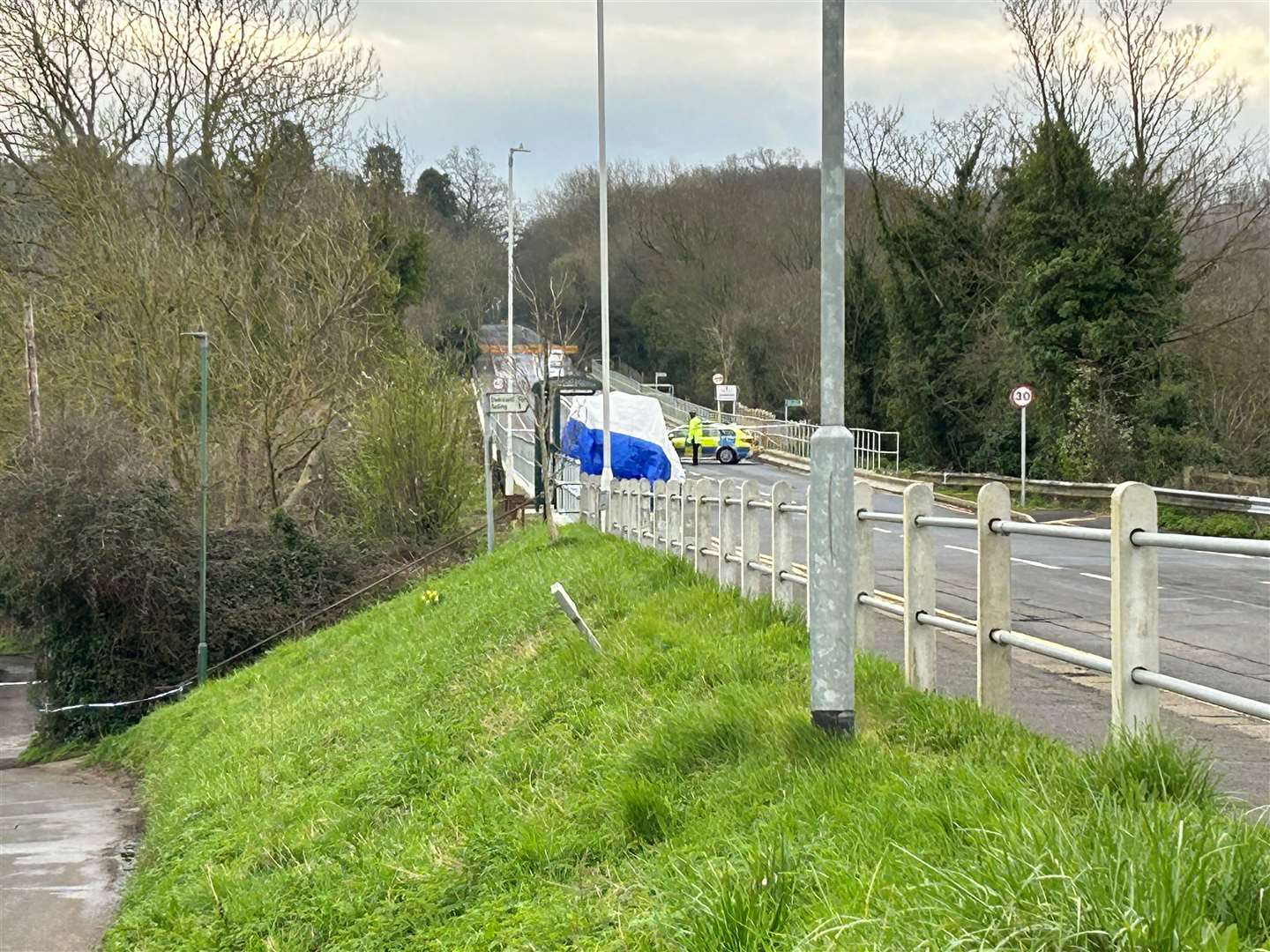 A white tent has been erected near a bus stop in the village