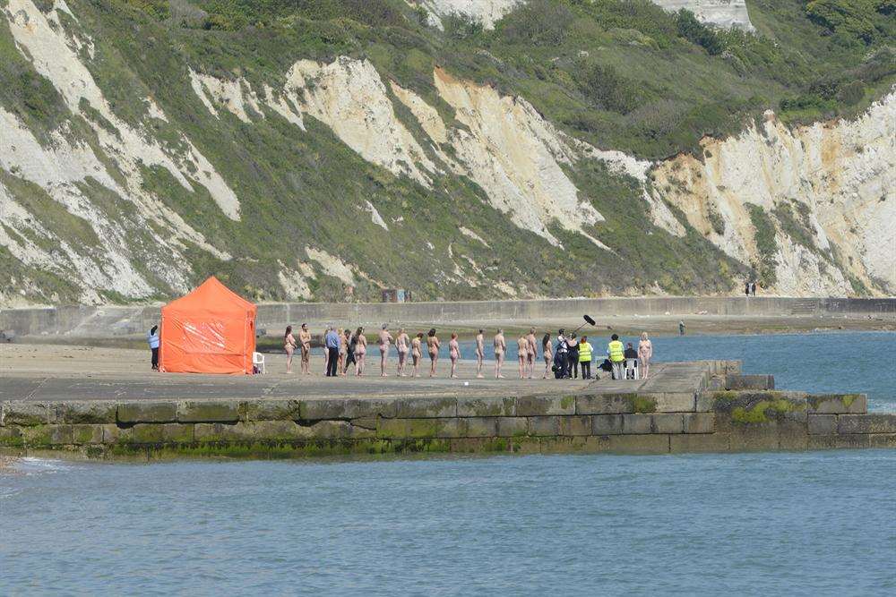 The group pose for photographic artist Spencer Tunick on The Warren in Folkestone. Picture: Simon Burchett