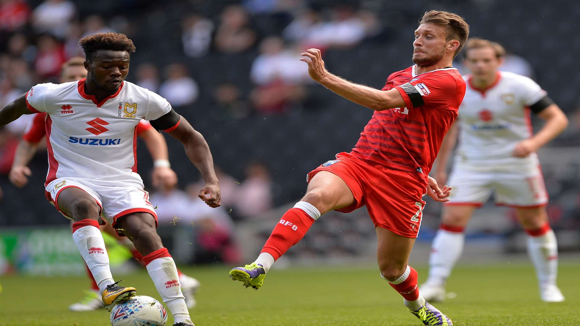 Gillingham’s Luke O’Neill challenges with MK Dons’ Gboly Ariyibi. Picture: Ady Kerry