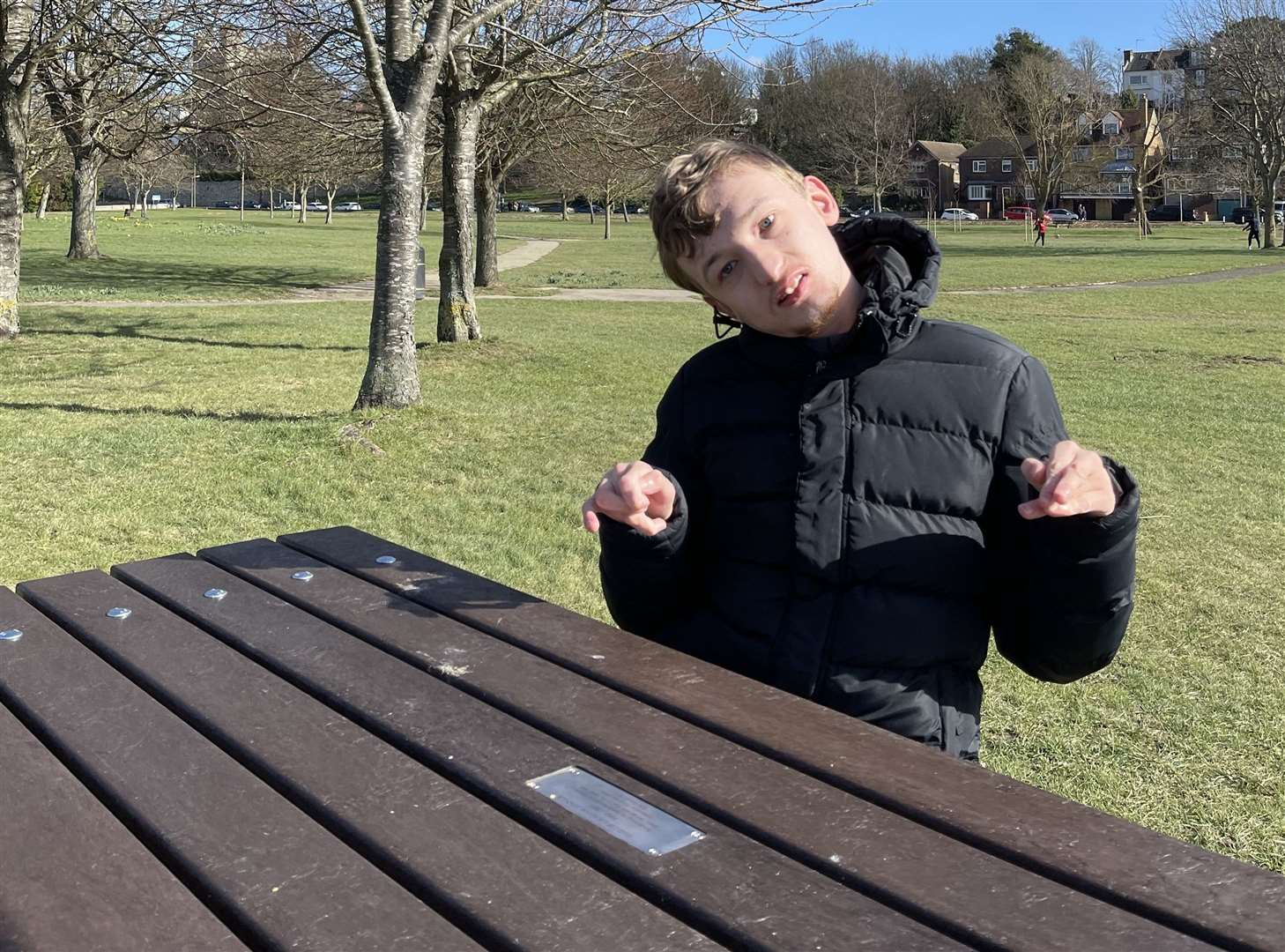 Helen's son Jack sitting at his late grandad's bench