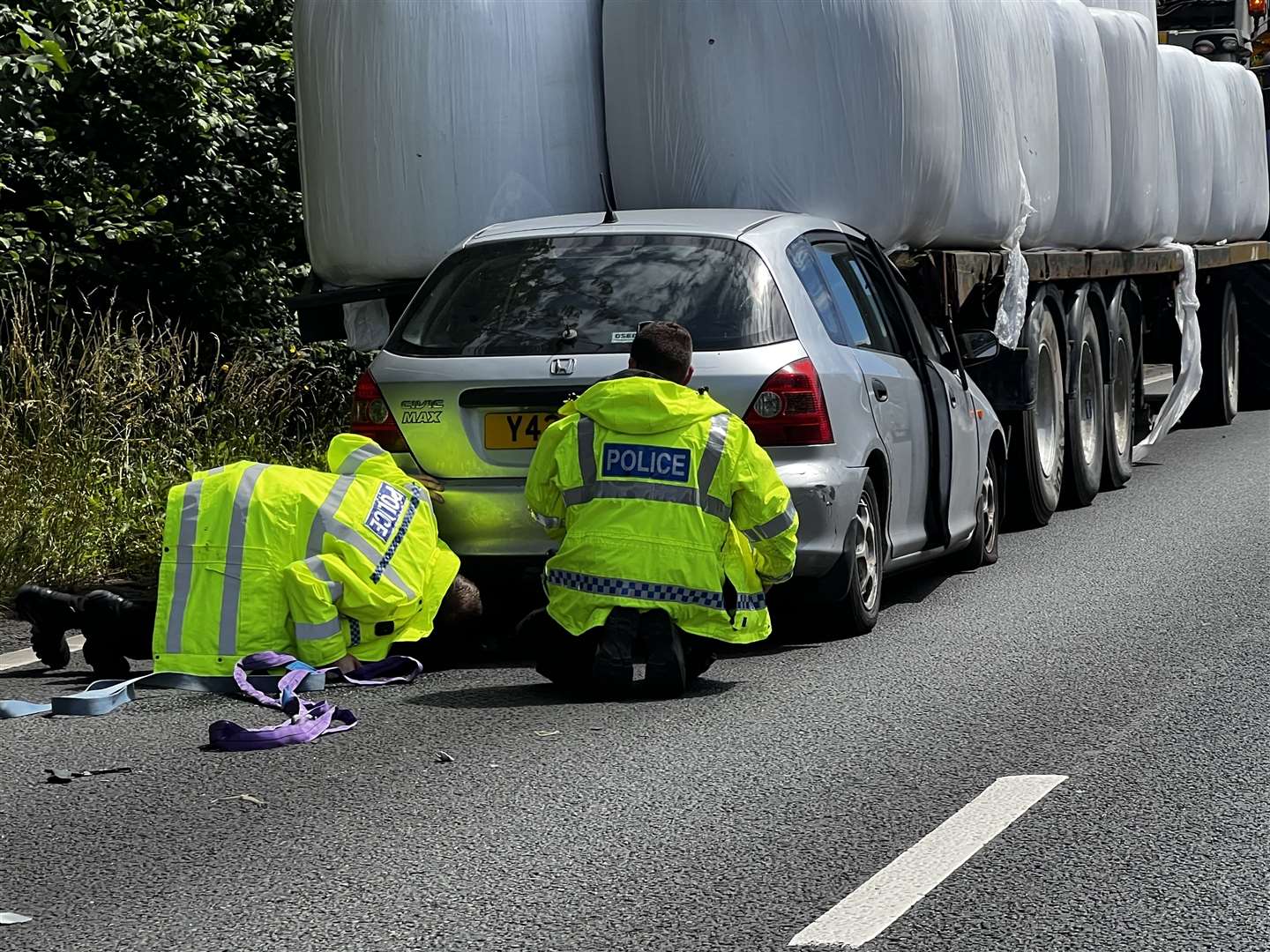 Police check the undercarriage of the stricken car. Picture: Steve R Salter