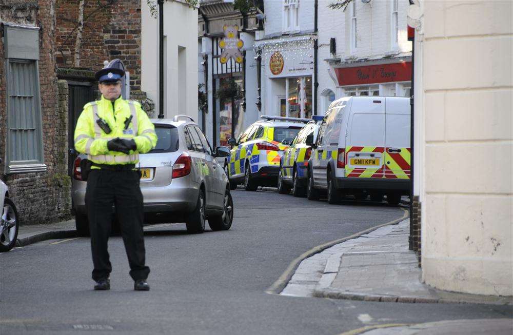 A policeman stands guard outside the crime scene