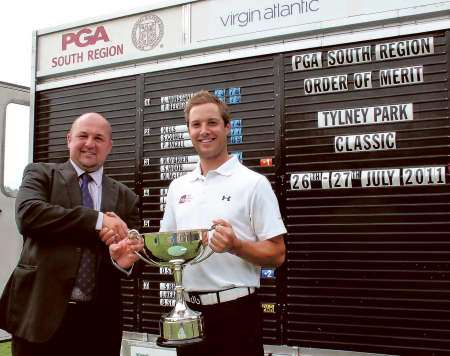 Richard Wallis receives his trophy from Tylney Park GC's vice-captain Neil Dawson