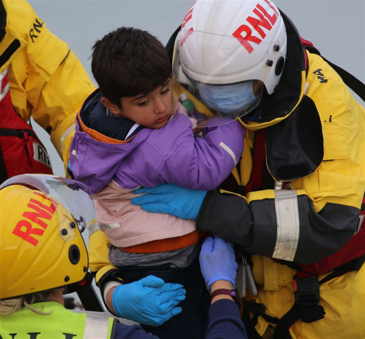 Crew from the RNLI helping a child