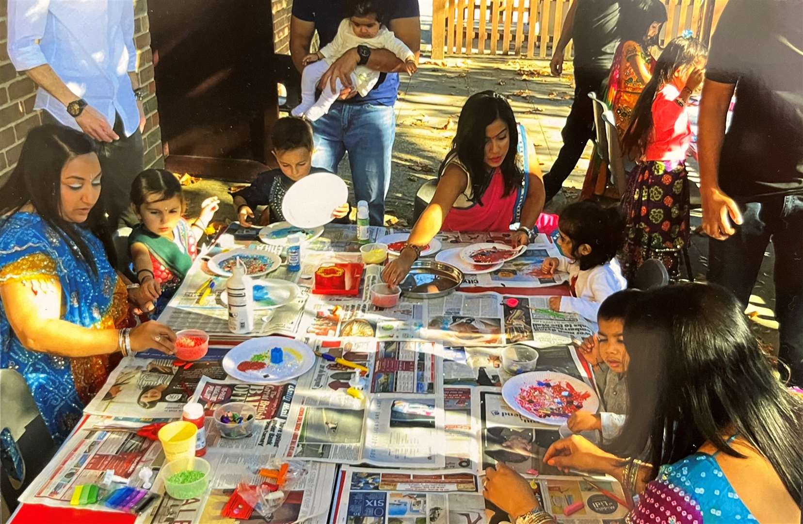 Young children making Arti plates for the hindu prayer ritual, puja