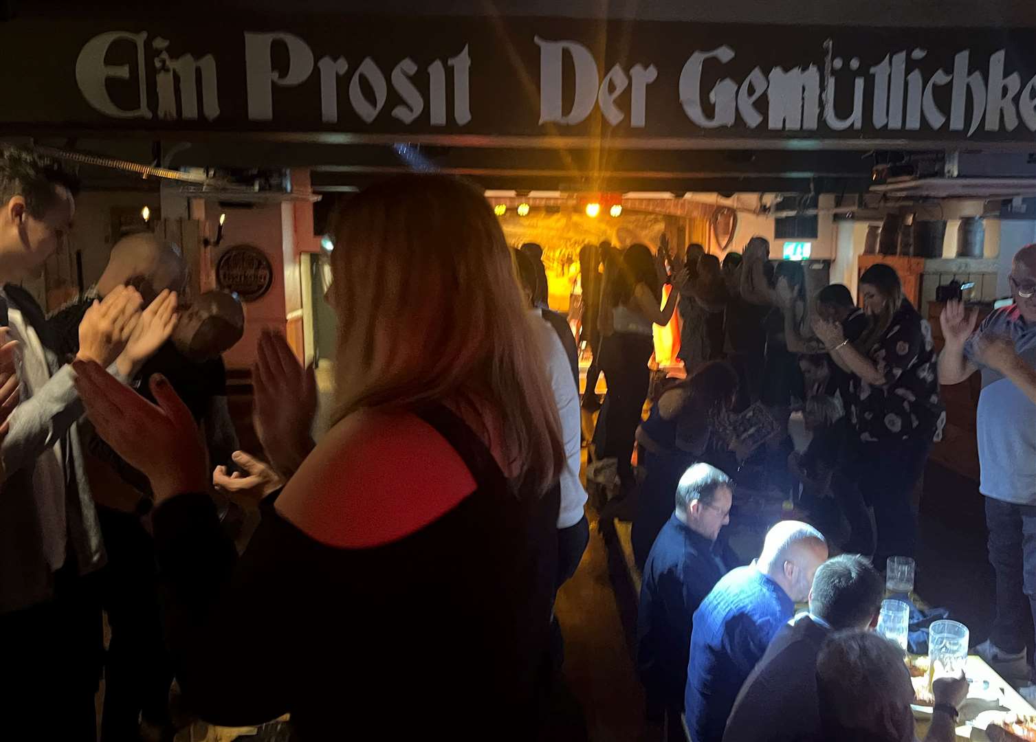 People dancing on the tables at Bierkeller, Maidstone