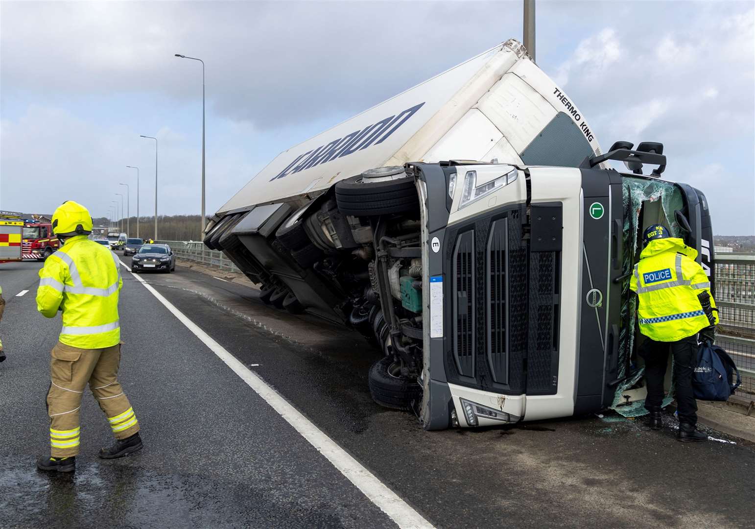 Fire crews and police helped recover the toppled lorry on the Medway Bridge. Picture: KFRS