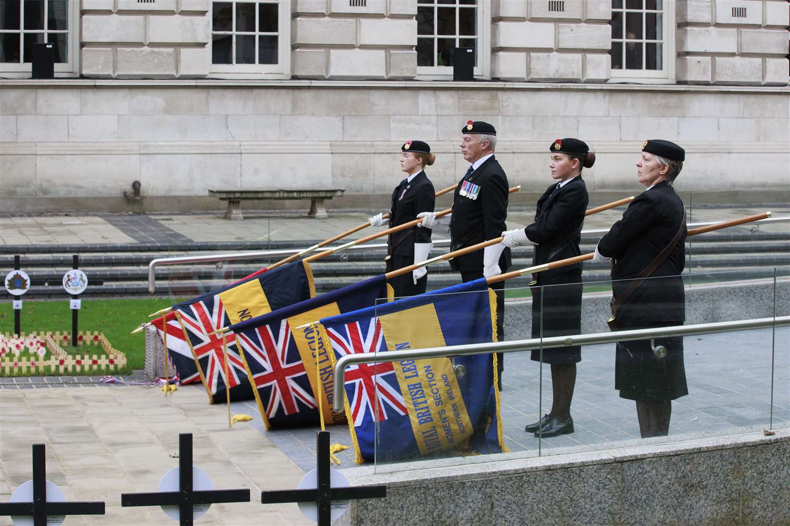 Flag bearers lower their flags at the opening of the Field of Remembrance at Belfast City Hall ahead of Armistice Day commemorations (Liam McBurney/PA)