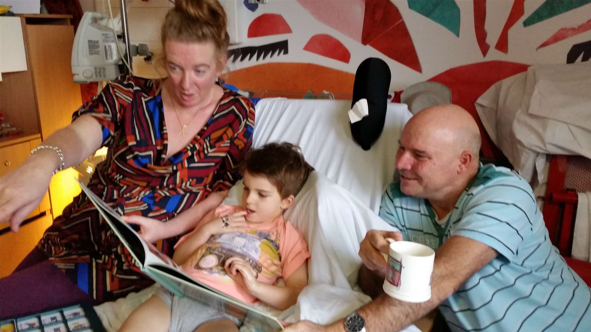 Samuel in hospital with his mum and dad