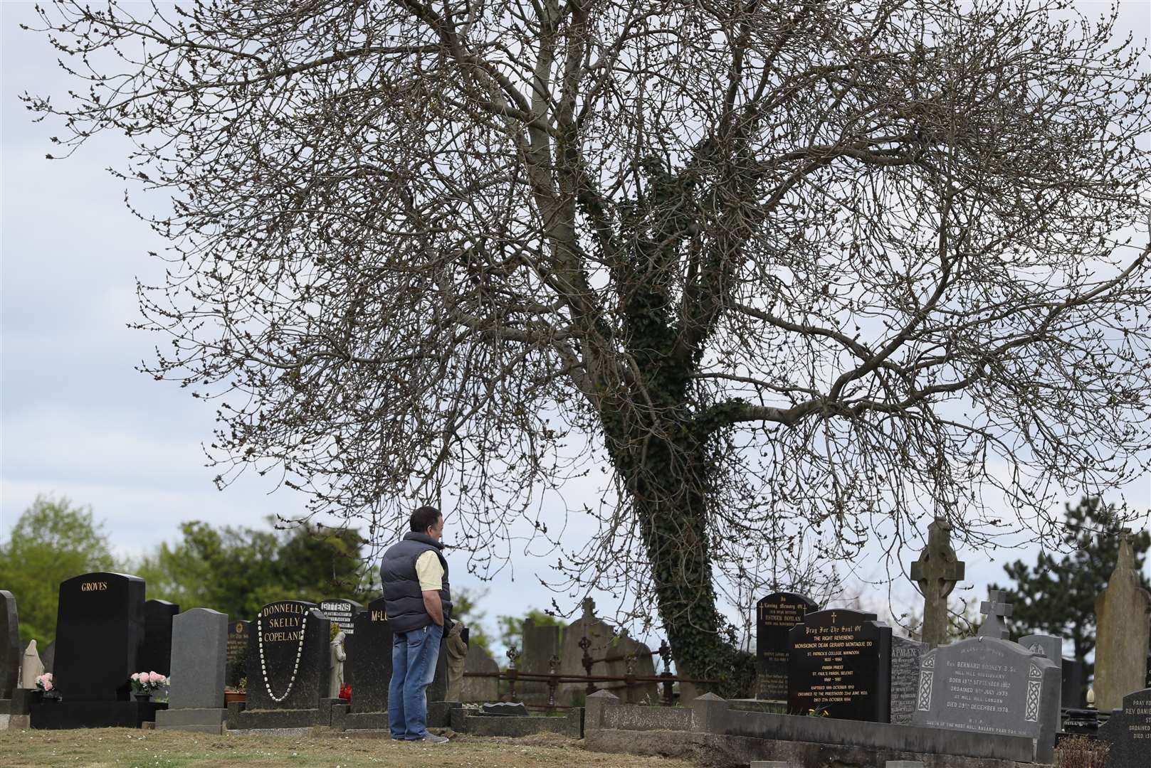 Milltown in West Belfast was busy with queues of people waiting to gain access (Brian Lawless/PA)