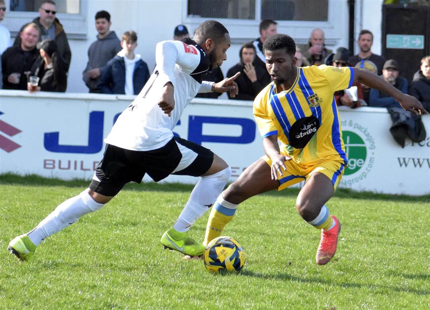 Kieron Campbell of Faversham runs at Sittingbourne wideman Donvieve Jones at Salters Lane in the away team's weekend 1-0 win. Picture: Randolph File