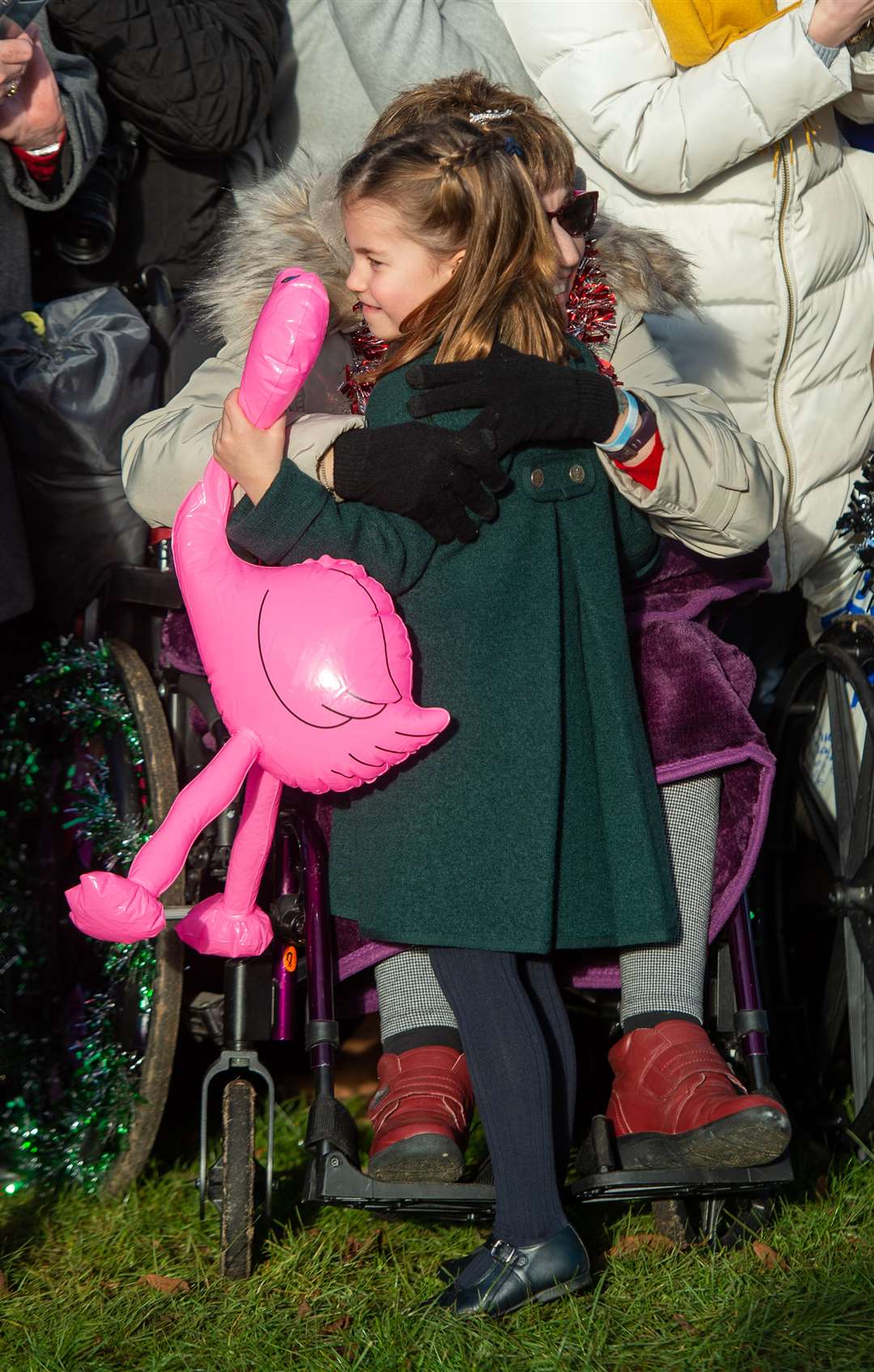 Gemma Clark from Lincolnshire hugs Princess Charlotte after giving her an inflatable flamingo (Joe Giddens/PA)