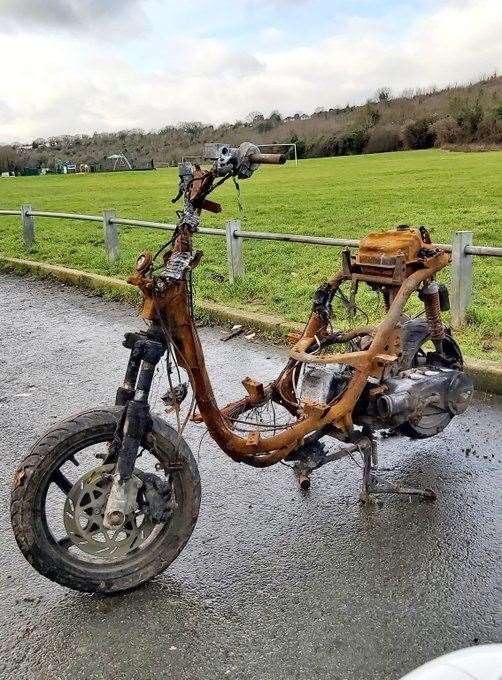 A stolen moped was found burnt out and destroyed near playing fields in Chatham. Picture: Kent Police