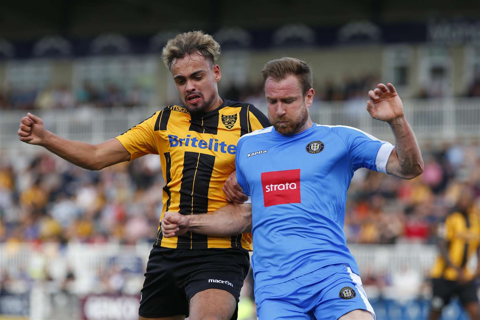 Maidstone midfielder Michael Phillips battles with Harrogate man Kevin Langmead Picture: Andy Jones