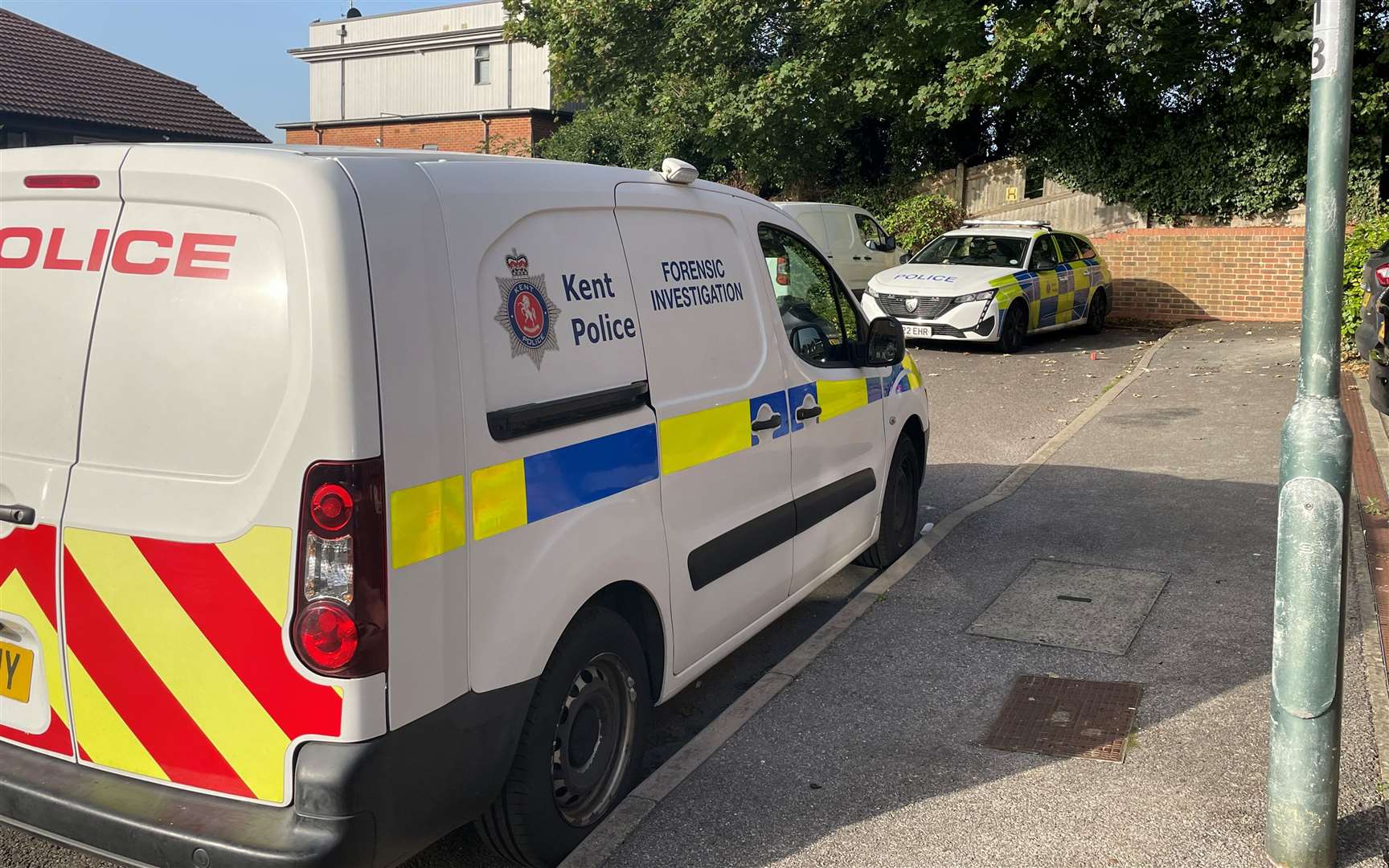 A forensics van is parked along the residential road in Borstal