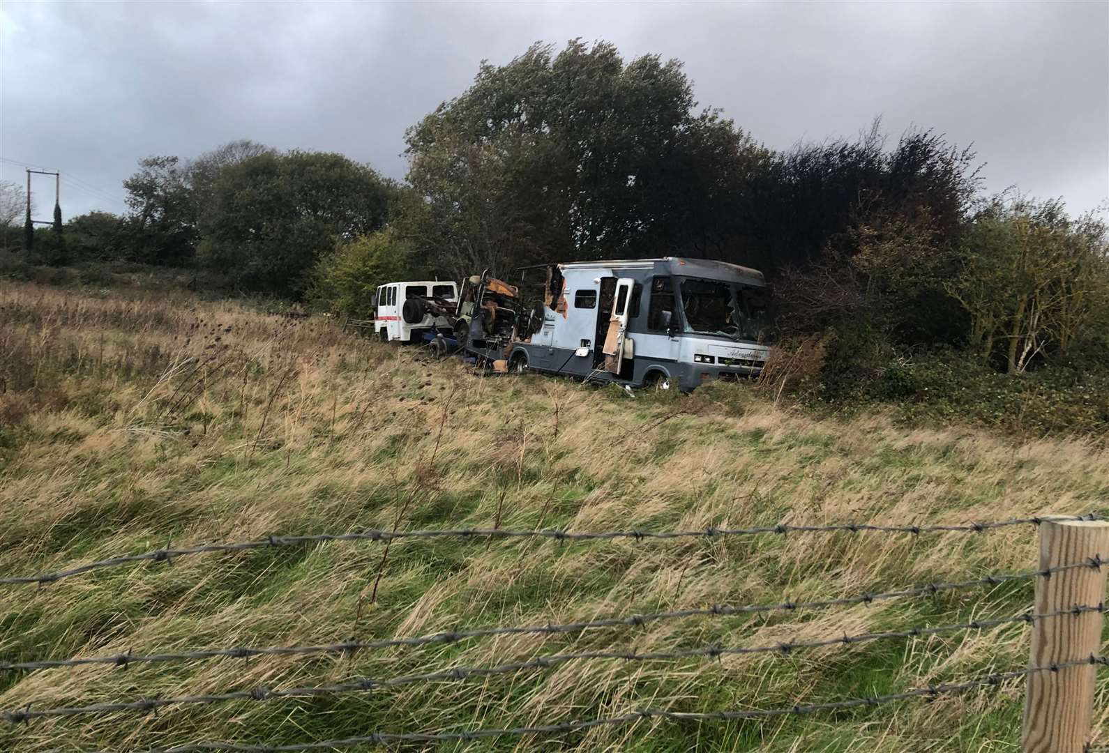 A resident said the vehicles have been abandoned in the field since 2020