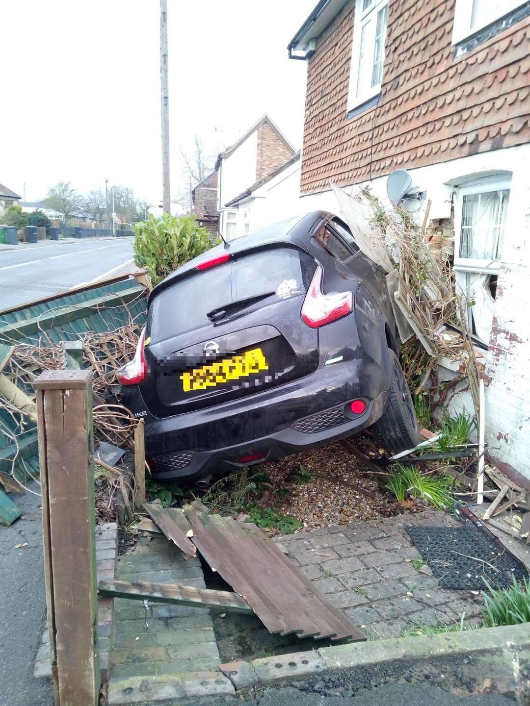 A black Nissan crashed into a house in Wheeler Street, Headcorn, at around 6.15am. Picture: Keith Armstrong