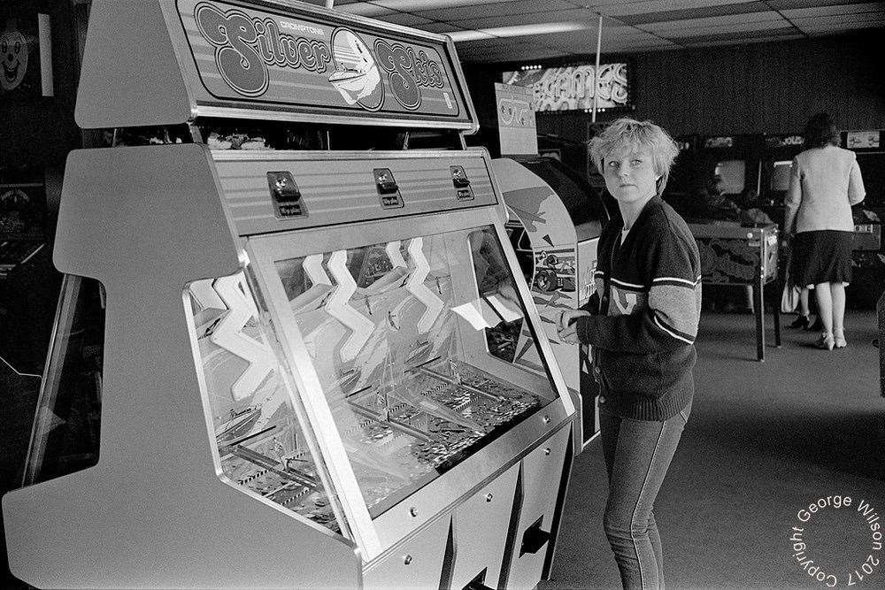 With a handful of coins, this girls tries her luck at Silver Skis. Copyright: George Wilson