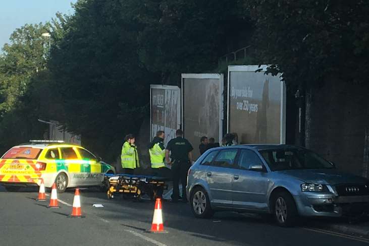 A motorcyclist was being treated at the scene.