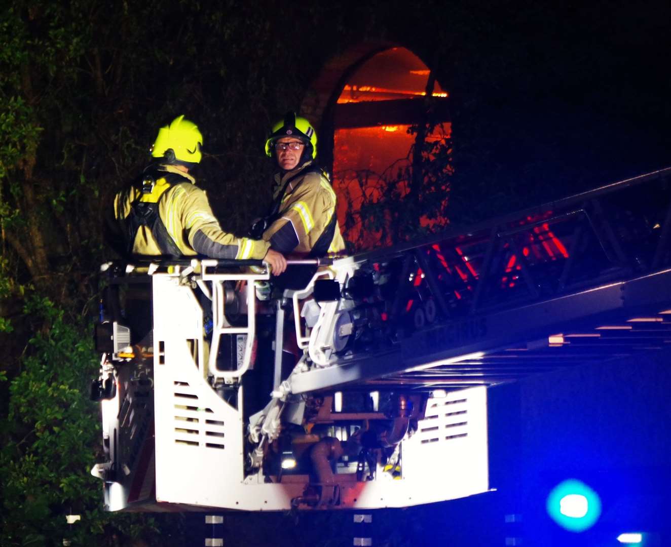 Firefighters using a crane to tackle the blazing water tower in Trinity Road, Sheerness. Picture: Phil Crowder