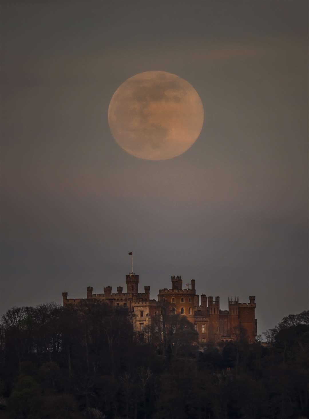 A pink supermoon is seen over Belvoir castle in Leicestershire (Danny Lawson/PA)