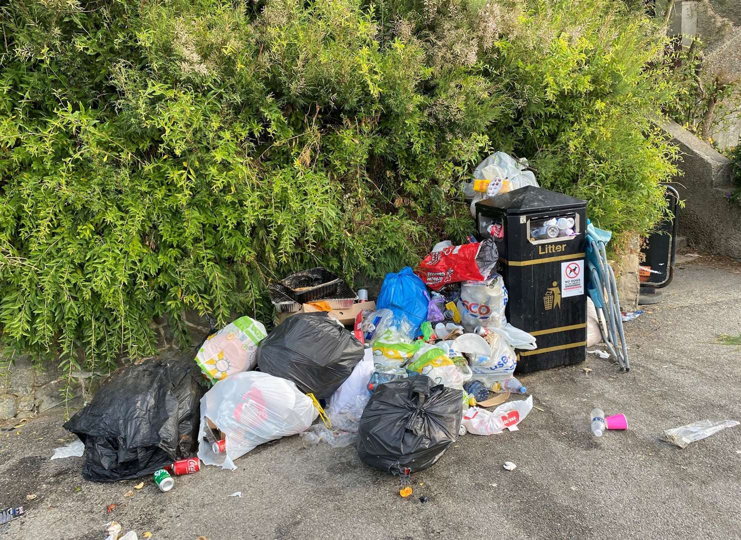 A beach chair was left by a bin, as well as bags of rubbish, in Folkestone Picture: Stephen West