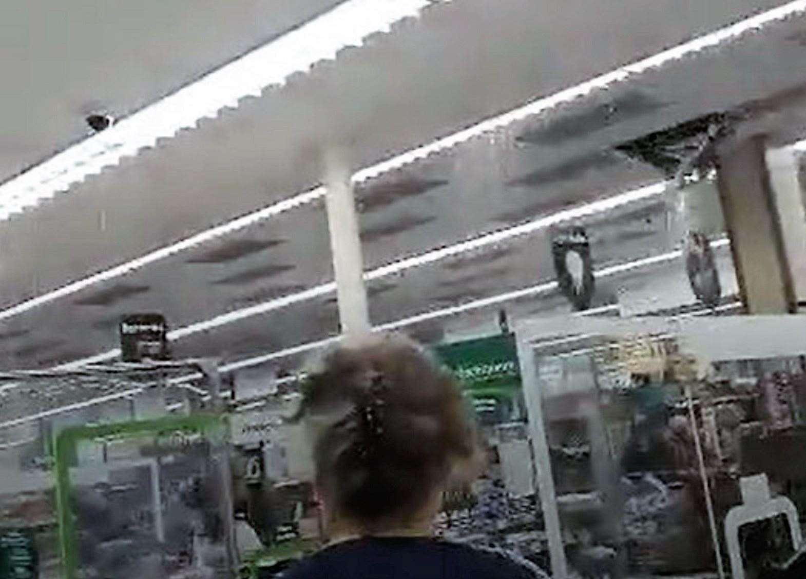 The moment more ceiling tiles fell through into the Morrisons store was caught on camera