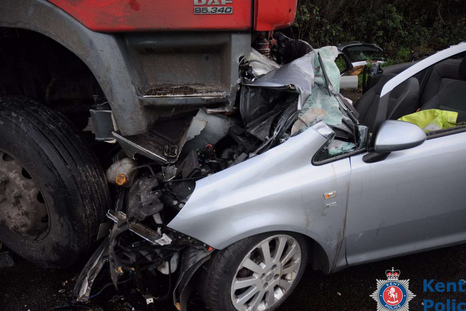 The car was stuck underneath the lorry.