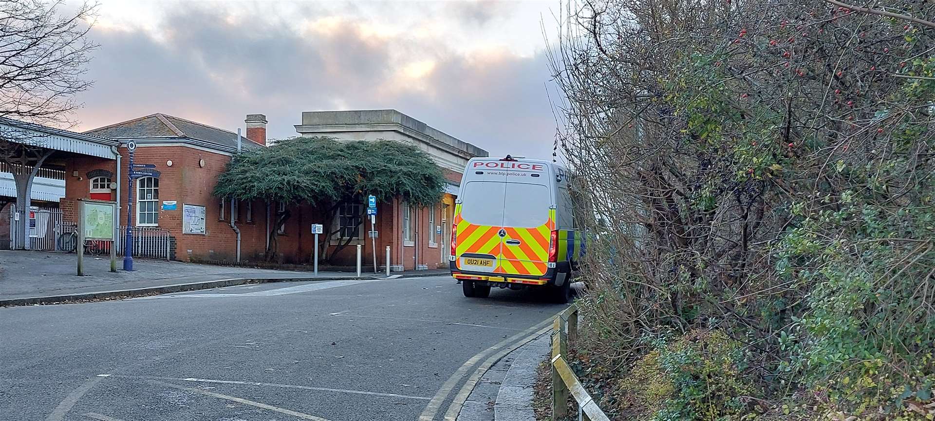 Police outside Whitstable train station following the stabbing of Modasher Hossain (pictured)