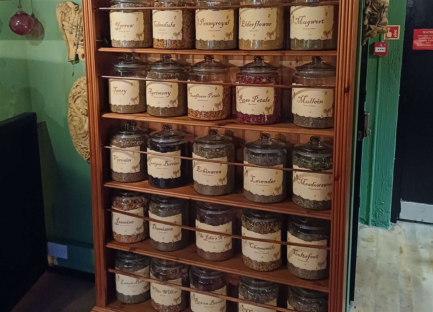 Shelves are stacked with jars of herbs which will be used for incense and energy spells