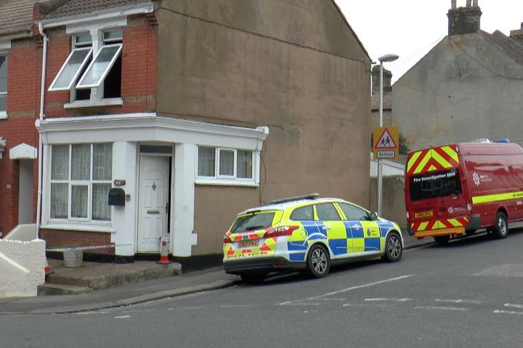 Police and fire investigators at the scene of the suspected arson attack