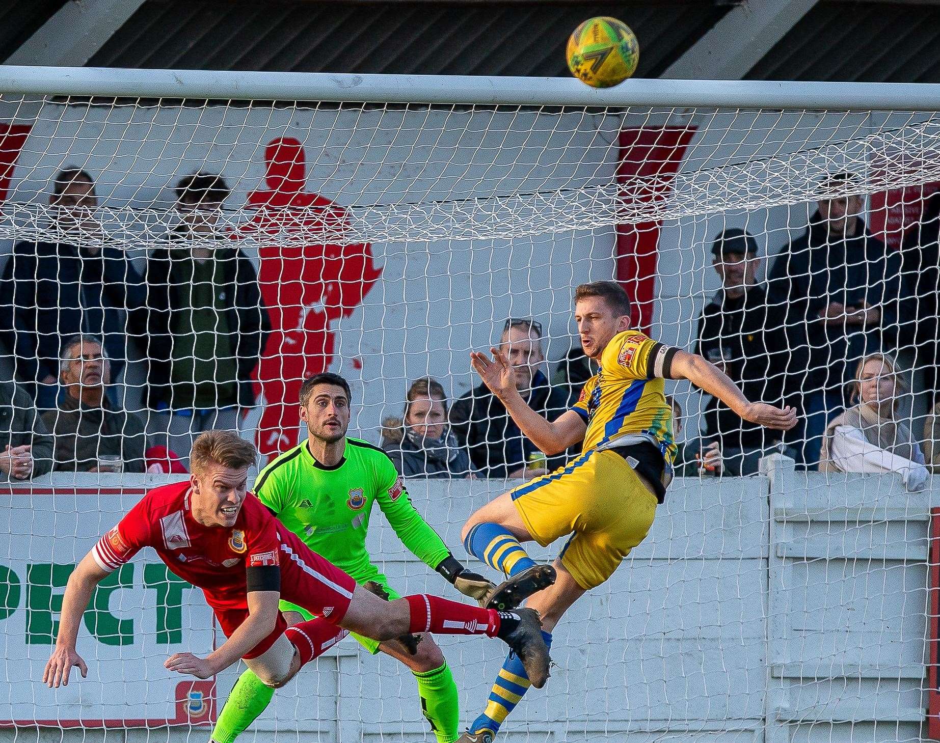 Whitstable defender Jack Miles heads clear under pressure from Sittingbourne's Kane Rowland during the Oystermen's home defeat. Picture: Les Biggs