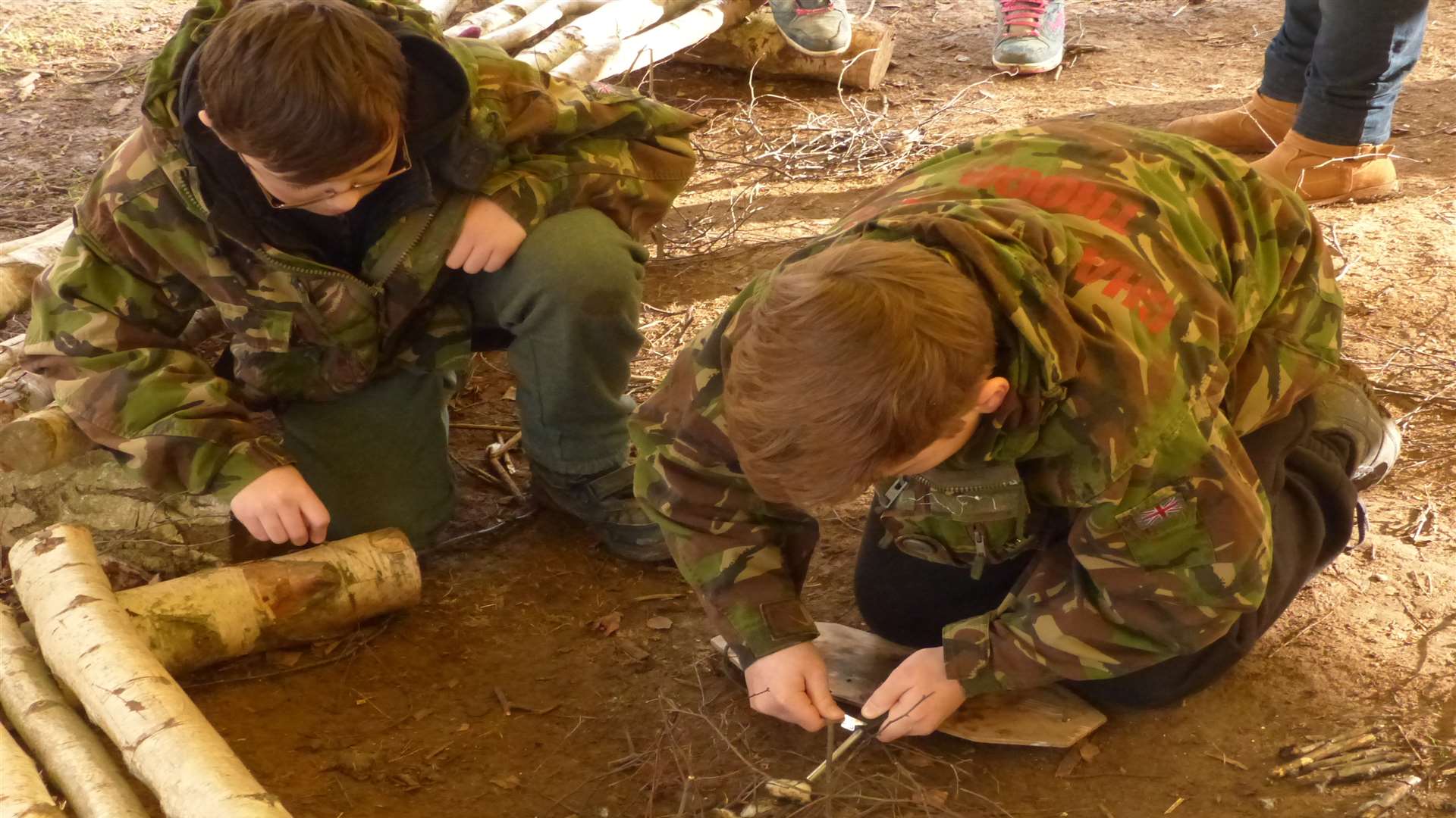 Creating a spark - two young participants from families in Swanley taking part in a basic firelighting session.