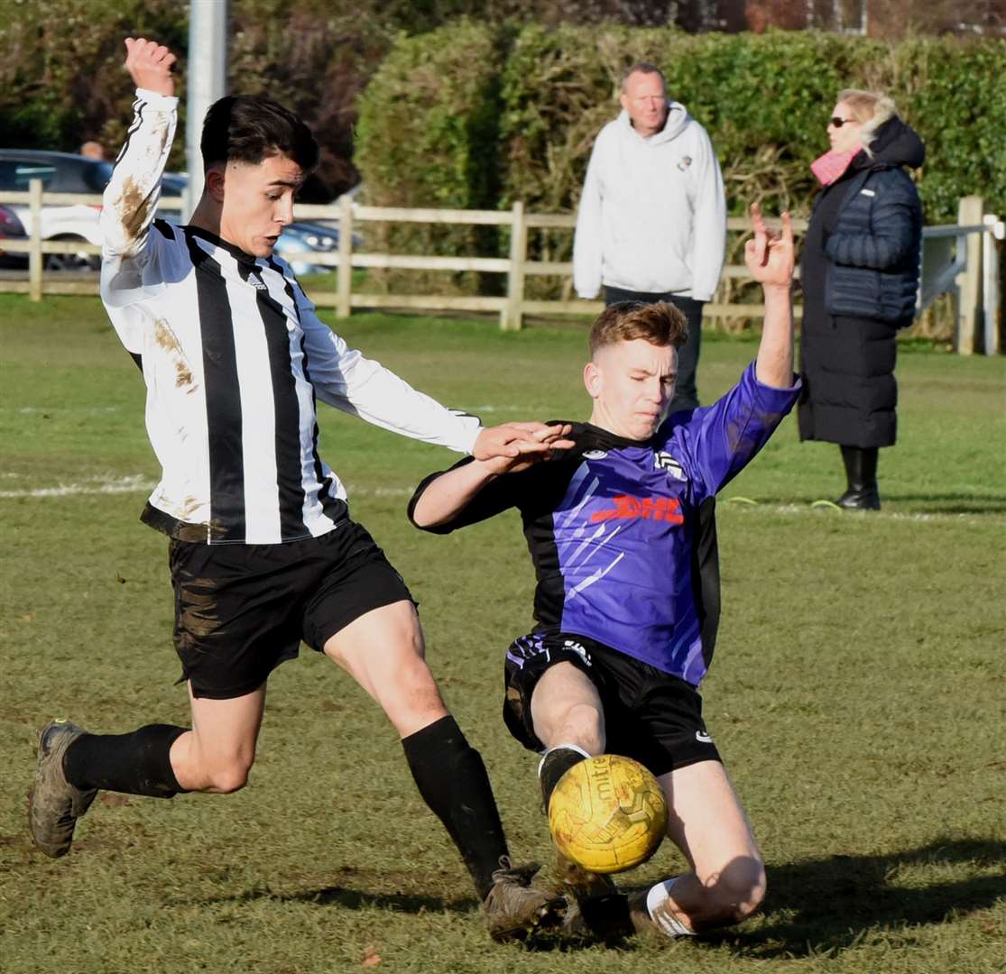 Anchorians United under-18s (purple) slide in against Real 60 Predators under-18s on Sunday. Picture: Ken Mears FM23729981