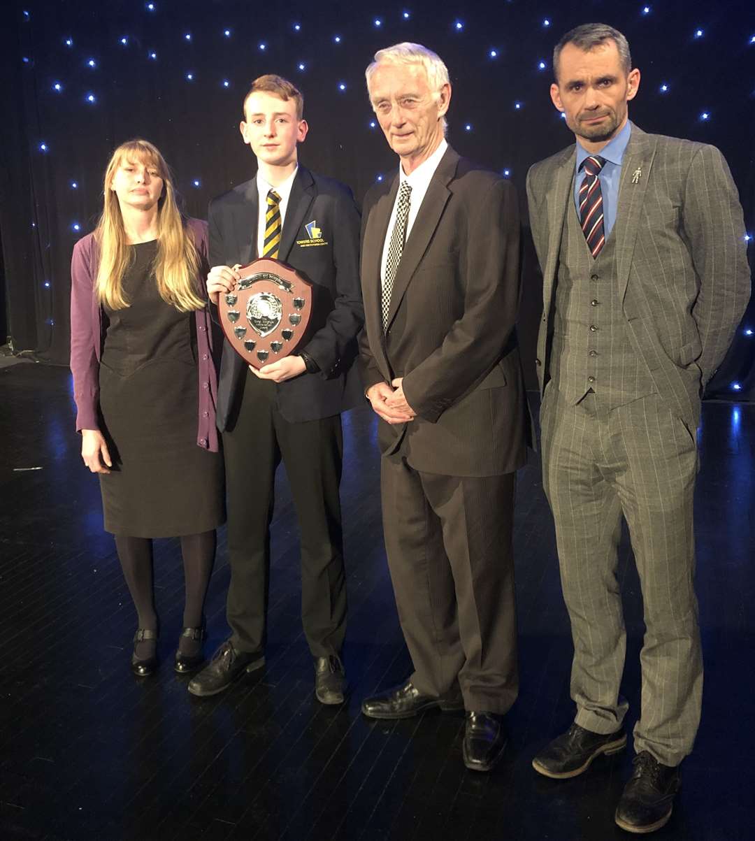 Rachael and David Kinghorn stand beside award recipient Jacob Kennedy and Towers School vice principal Rob Gaygan