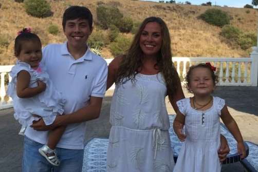 Jesse holding Teddy, Sarah and Poppy on holiday in Spain