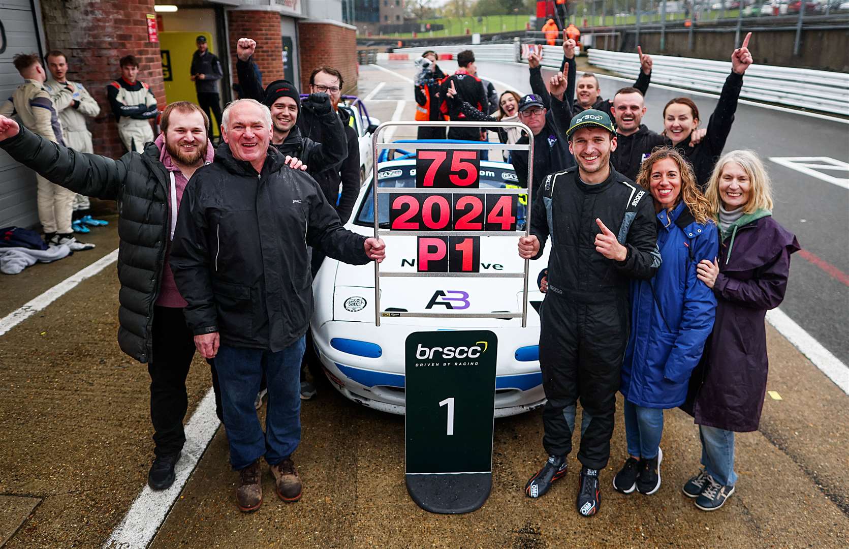 Dartford's Thomas Langford and his family and team colleagues celebrate his title success at Brands Hatch. From left are Will Langford, Steve Langford, Harry Deane, Danny Stanford-Ravet, Tilly Stanford-Ravet, Chris Flynn, Brad Cooper, Ali Bray, Niki Bray, Thomas Langford, Laura Pallares-Bertran and Jane Langford. Picture: James Roberts Photography