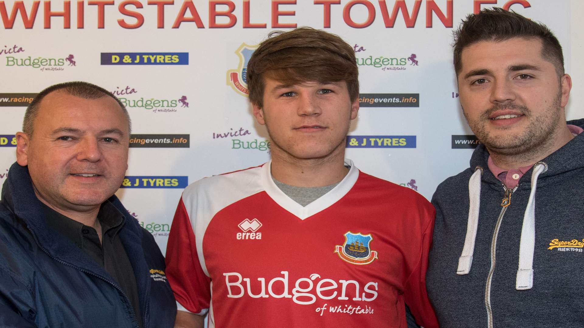 Aaron James, flanked by Town chairman Gary Johnson, left, and manager Will Graham Picture: Les Biggs