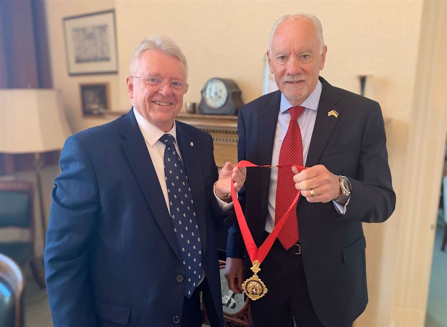 Cllrs Gary Cooke, left, and Bryan Sweetland swap chains of office in May 2024