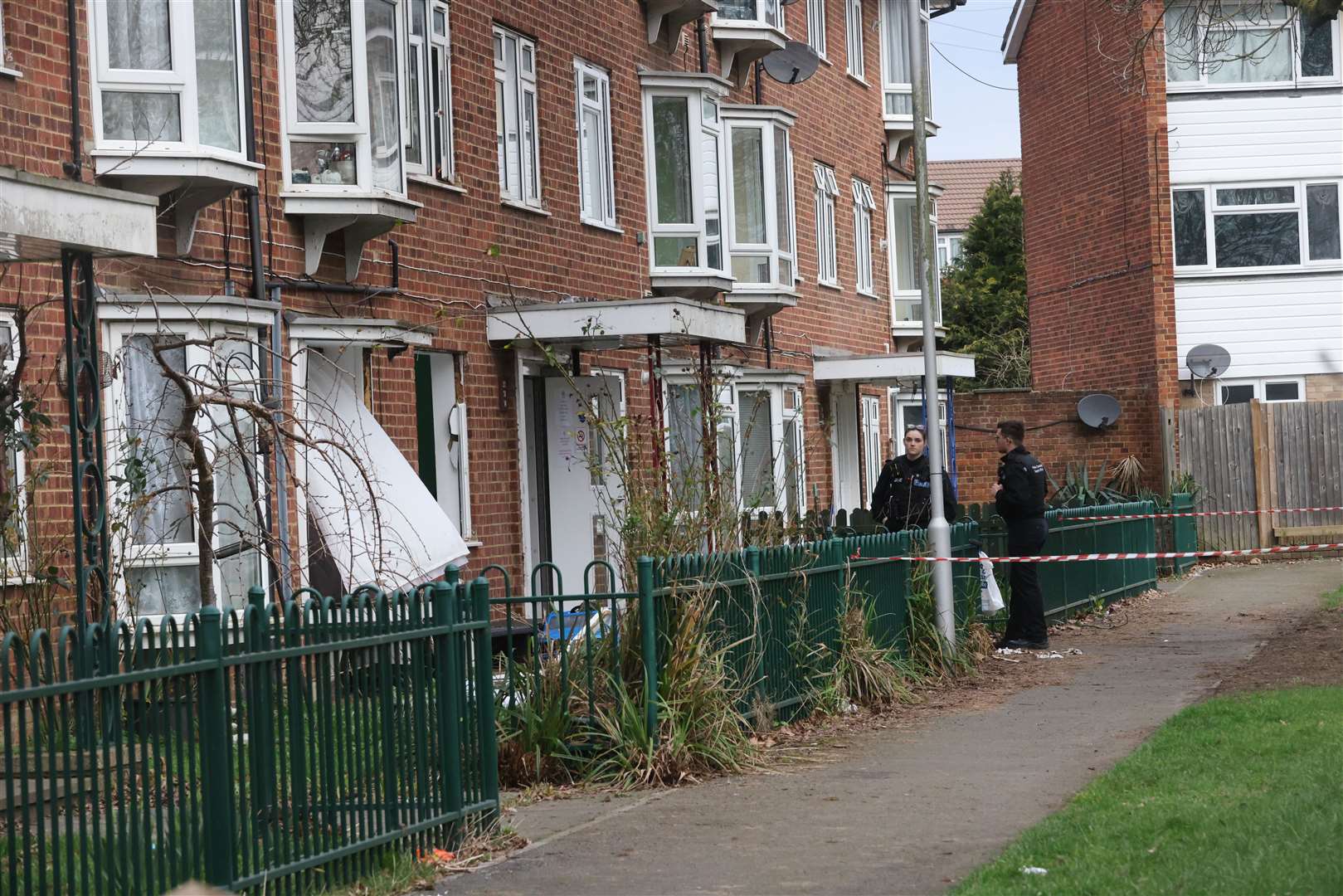 A large police cordon was in place along a grass area at the rear of the block of flats in Catlyn Close in East Malling. Picture: UKNIP