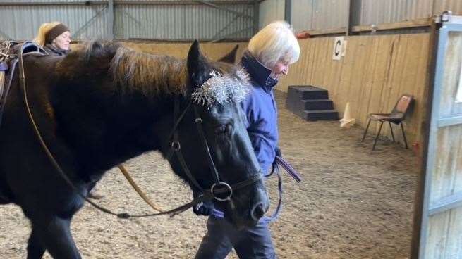 Val Blake leading one of the Arrow Riding Centre's horses