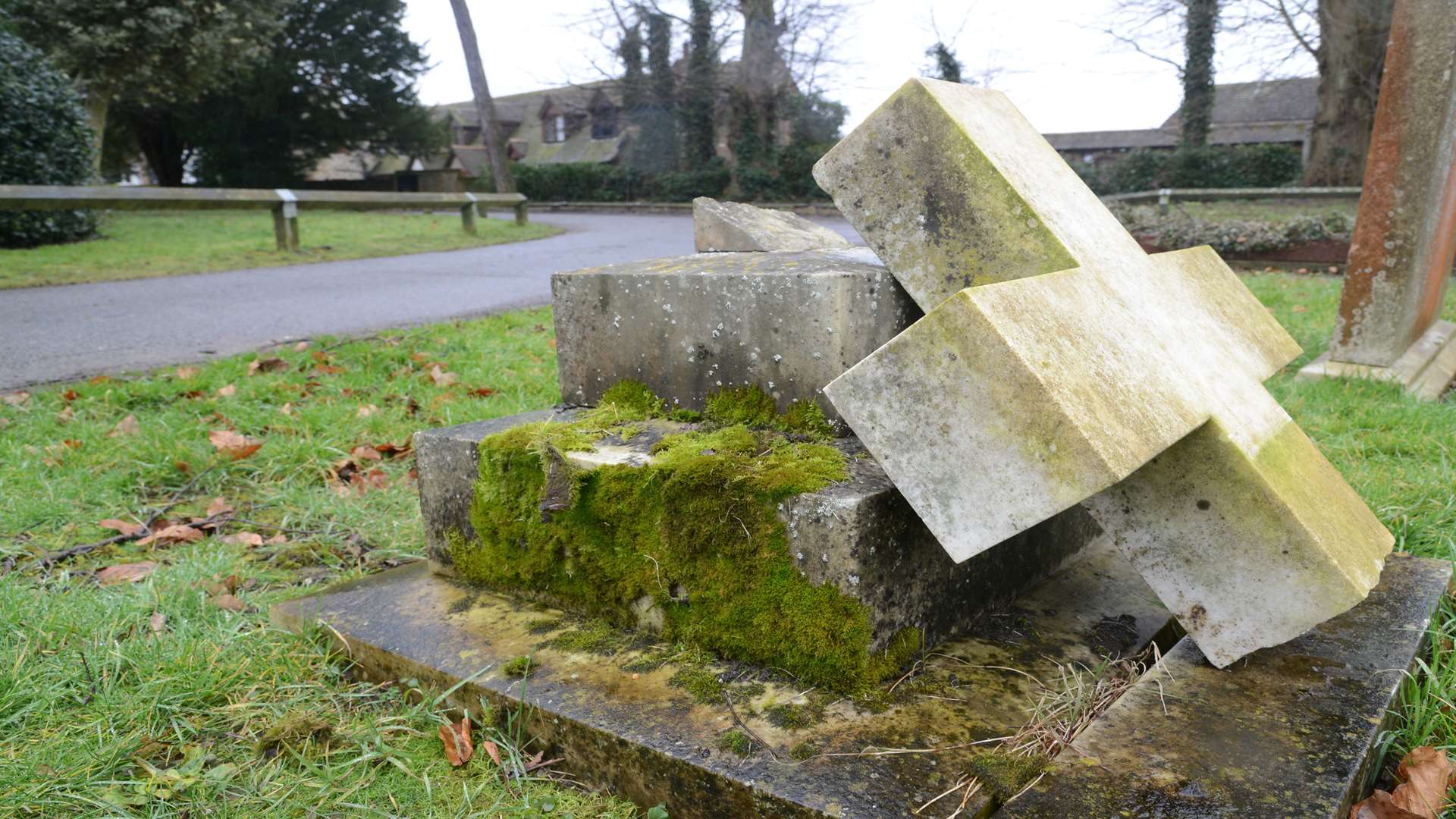 A gravestone near the entrance has been knocked down