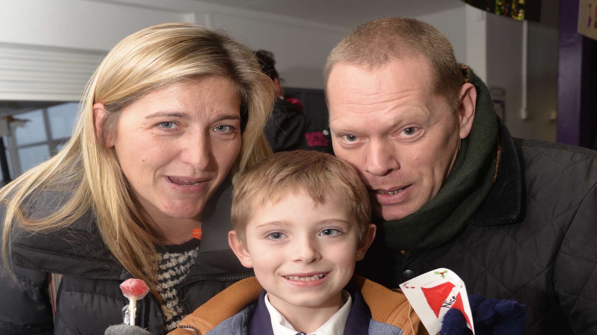 Harry Cannon, eight, with parents Joanne Cannon and Simon Wharf, wins a prize on the sweet tombola.