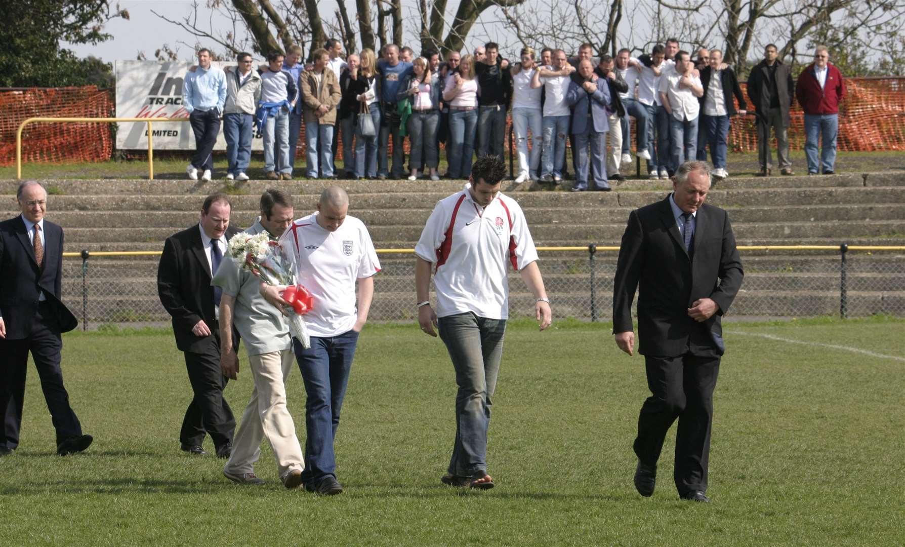 Supporters pay their respects before the game against Heybridge with Neil Cugley (right) followed by Paul Sykes' brothers and father