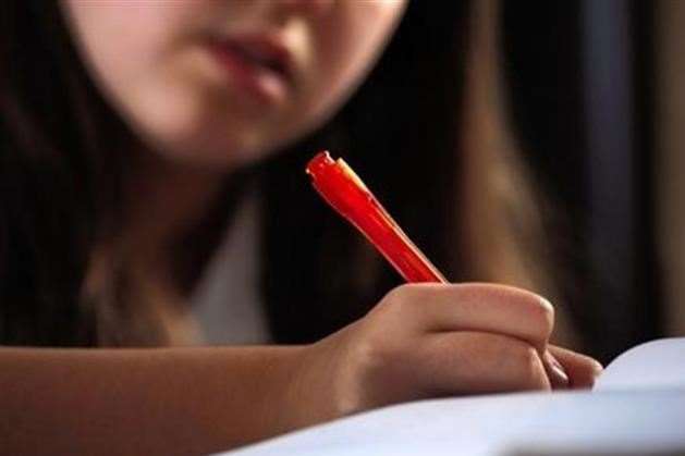 A child writing in class. Stock photo