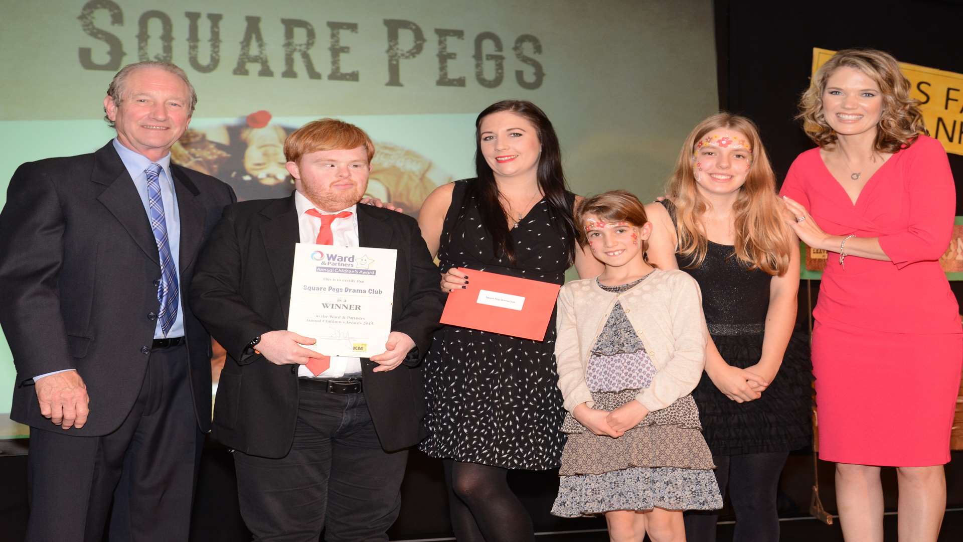 Charlotte Hawkins and Paul Rooney presenting an award to Beth James and members of Square Pegs Drama Club, Sam Ashby, Sharne Elphick and Rosie Scholefield