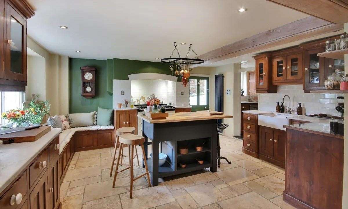 The modern kitchen has marble worktops, bespoke cabinets and an adjoining utility room. Picture: Knight Frank